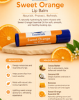 Sweet Orange Lip Balm packaging with ingredients and benefits on a wooden board with oranges and flowers.