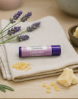 Organic Lavender Lip Balm tube with cocoa butter, beeswax, and lavender on neutral background, ideal for dry lips