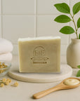 Yarrow & Witch Hazel facial soap bar on marble tray with wooden spoon and natural botanicals for gentle, moisturizing skincare