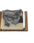 Charcoal & Sea Clay Bar Soap on a wooden soap dish