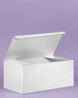 White gift box with lid against purple background, showcasing sleek, elegant design ideal for any occasion.