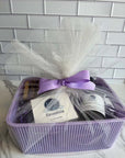 Lemongrass gift basket with soaps, wooden dish, purple ribbon in purple basket.