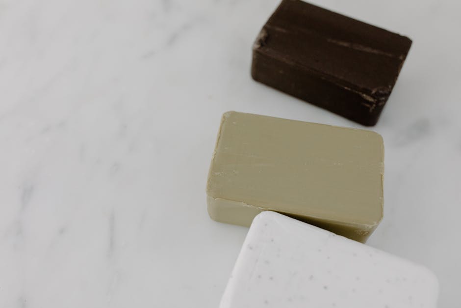 High-angle view of assorted bar soaps on marble, perfect for beauty and cosmetic themes.