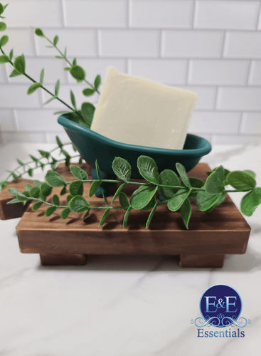 Eucalyptus & Mint Soap on a wooden tray with green leaves, for natural and organic skincare.
