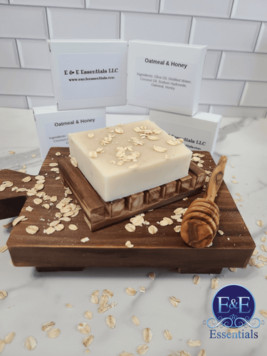 Oatmeal and Honey Bar Soap on wooden tray with oats and honey dipper, showcasing natural ingredients and packaging.