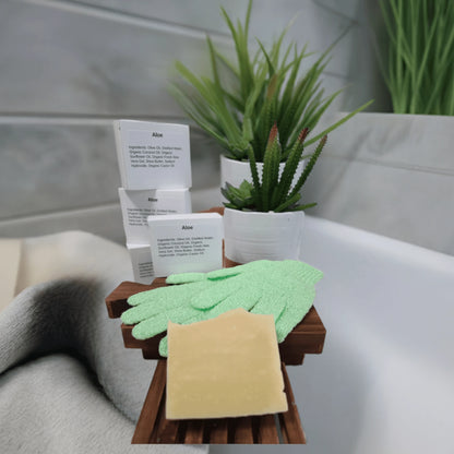 Aloe & Shea Butter Bar Soap displayed with gloves and greenery on a bathroom sink