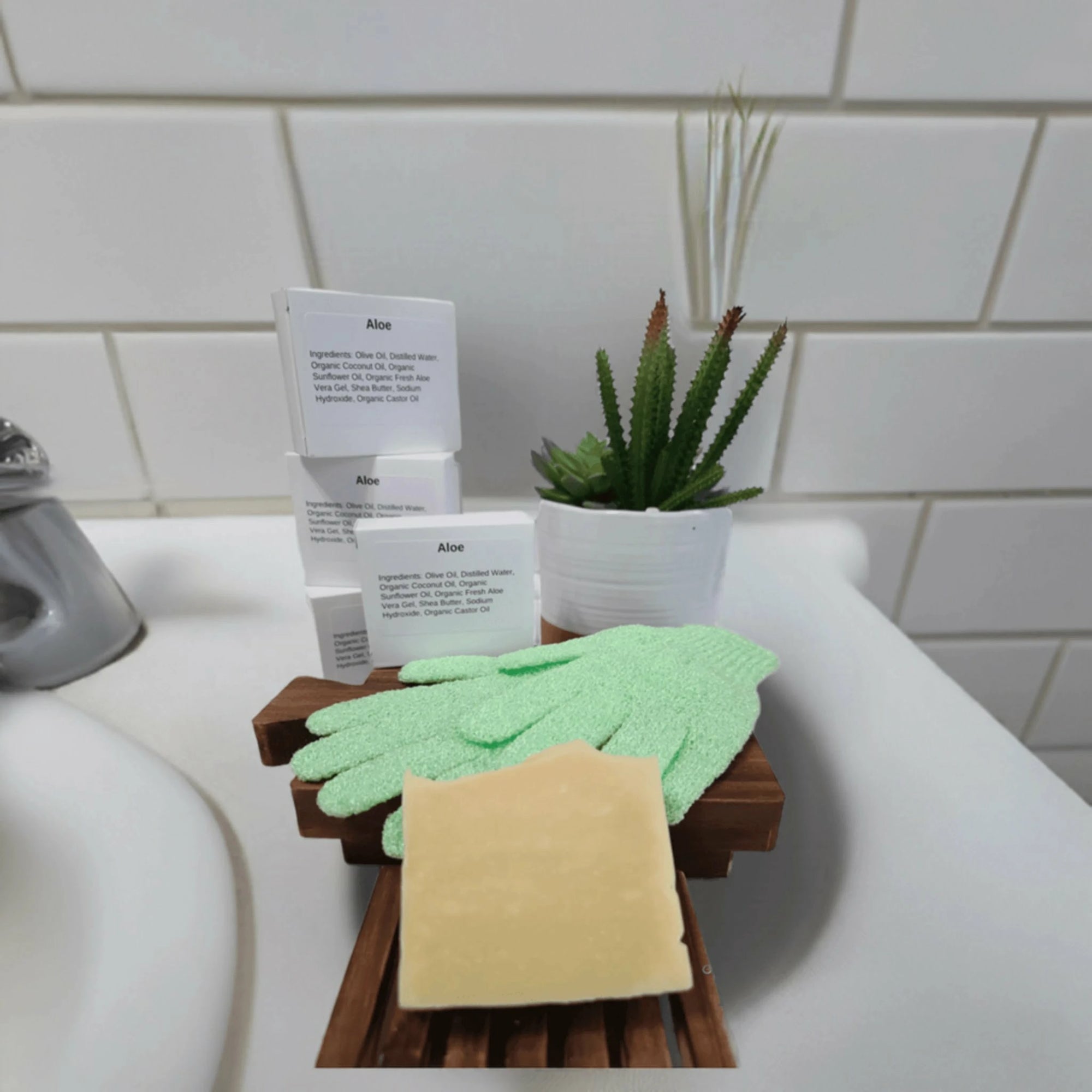 Aloe &amp; Shea Butter Bar Soap displayed with gloves and a green plant on a counter