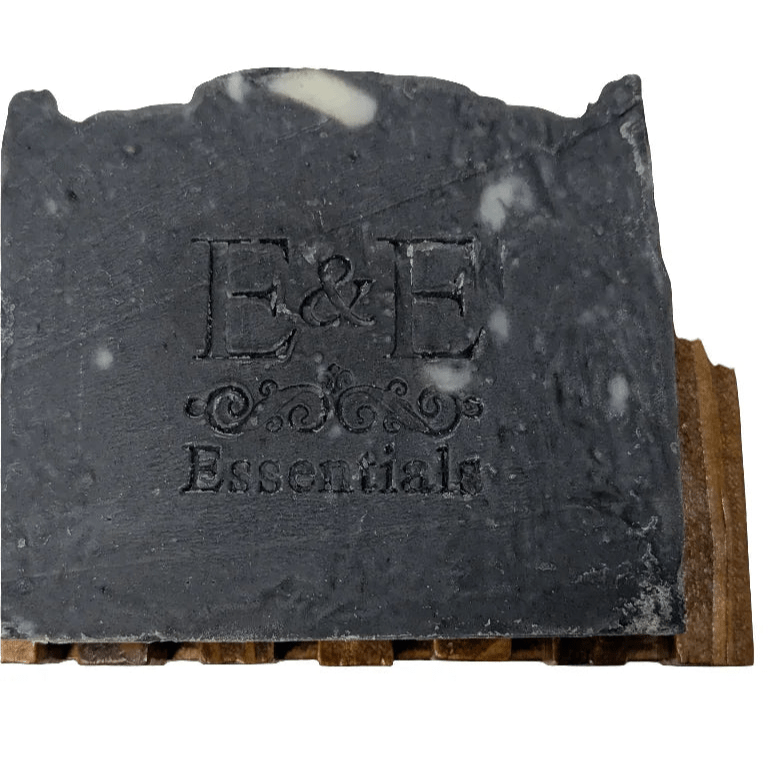 Activated charcoal bar soap with E & E Essentials logo on wooden holder, natural face cleanser