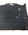 Activated charcoal bar soap with E & E Essentials logo on wooden holder, natural face cleanser