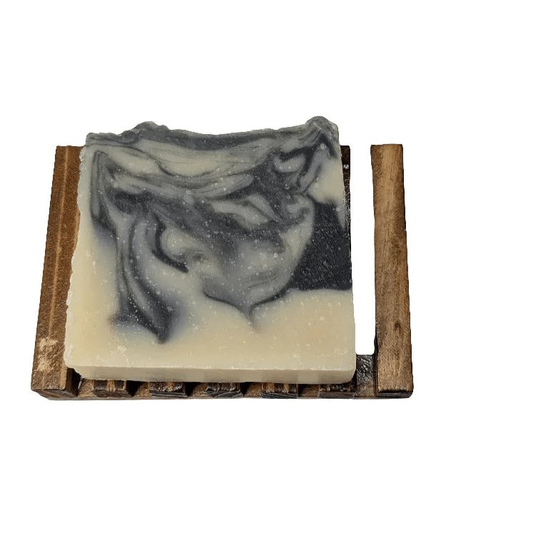Charcoal &amp; Sea Clay Bar Soap resting on wooden dish, eco-friendly handmade soap for acne-prone skin.