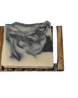 Charcoal & Sea Clay Bar Soap resting on wooden dish, eco-friendly handmade soap for acne-prone skin.