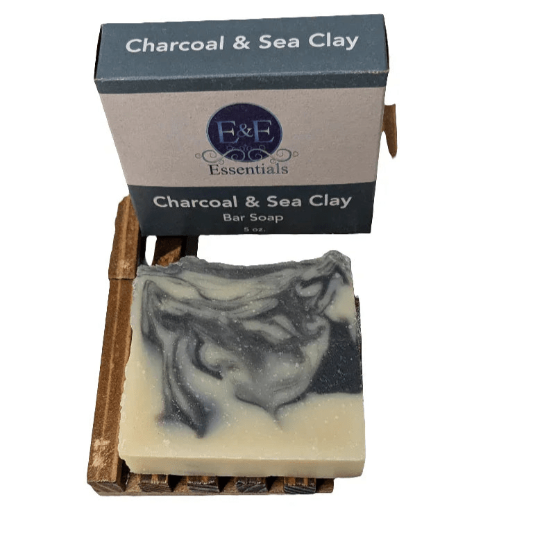 Charcoal &amp; Sea Clay Bar Soap displayed with box and wooden dish, handcrafted for oily and acne-prone skin.