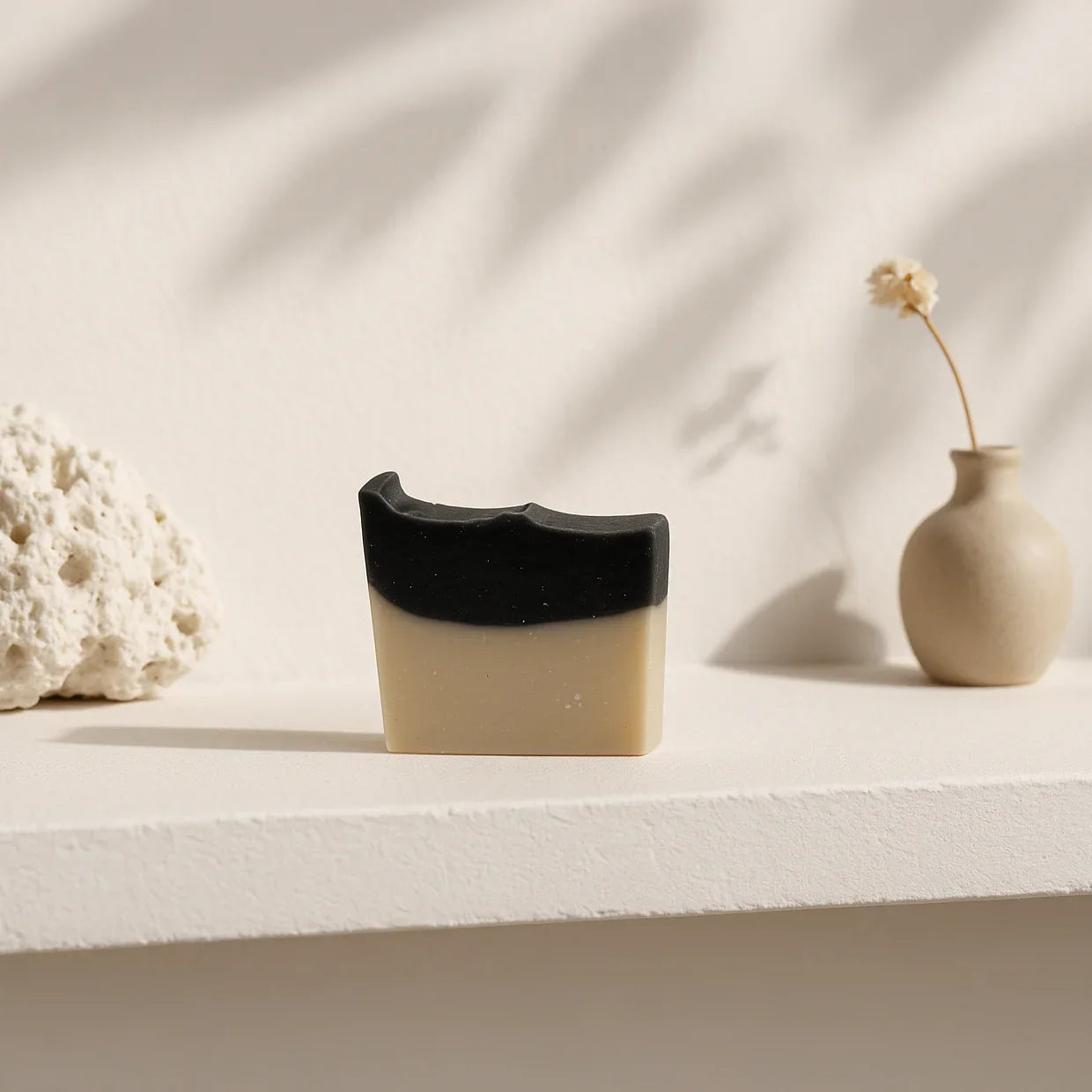 Natural charcoal and sea clay bar soap for deep pore cleansing and skin detoxification, suitable for face and body.