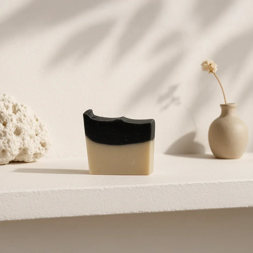 Natural charcoal and sea clay bar soap for deep pore cleansing and skin detoxification, suitable for face and body.