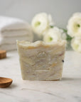 Gumbo Bar Soap handmade natural artisan soap bar with gentle ingredients on marble surface with wooden spoon and white flowers background