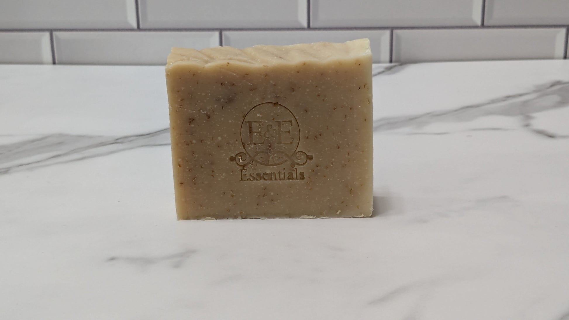 Oatmeal & Honey Bar Soap with its embossed logo visible