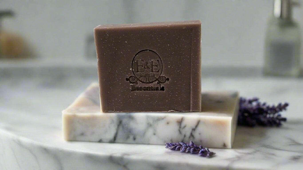 Lavender bar soap on a marble surface with lavender sprigs.