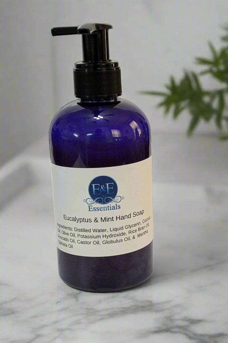 Eucalyptus & Mint Hand Soap in blue bottle on marble surface.