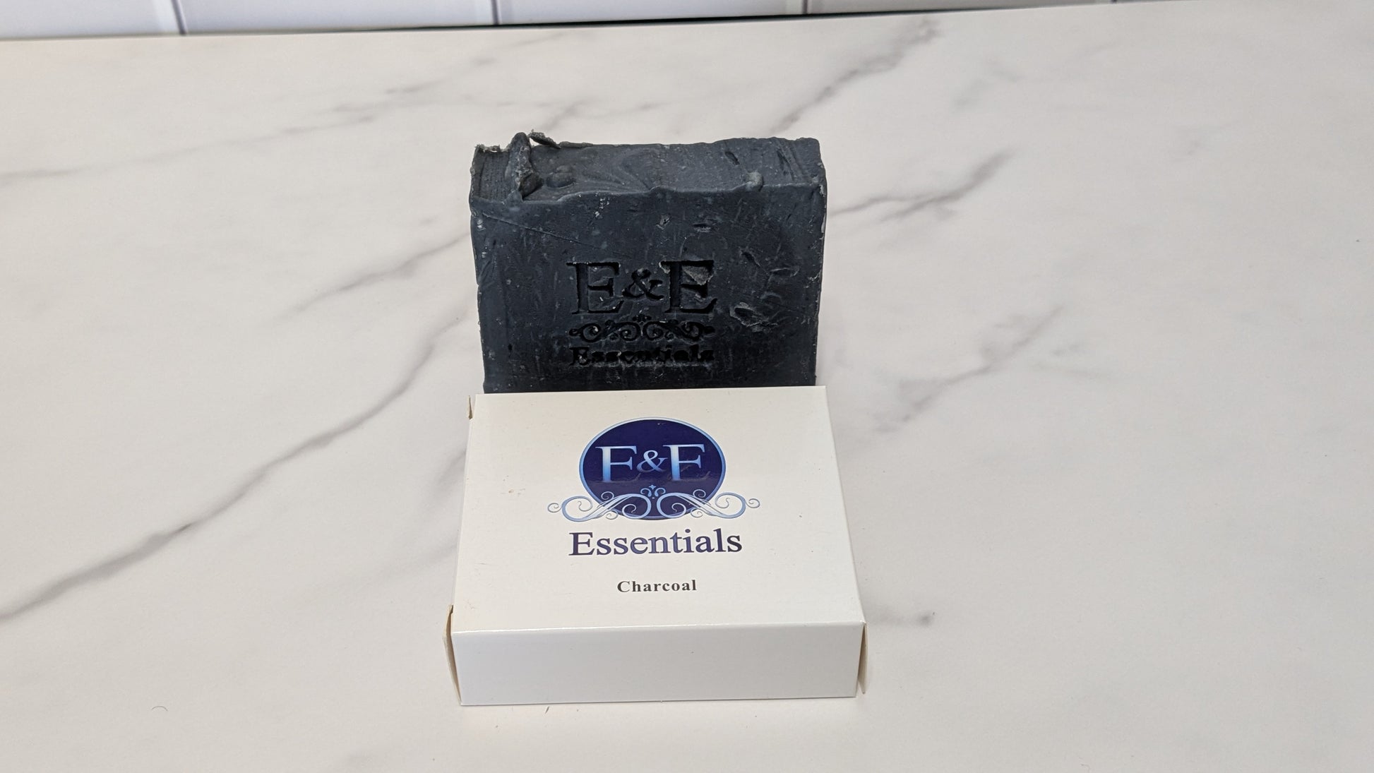 Charcoal bar soap with a dark label displayed on a clean surface