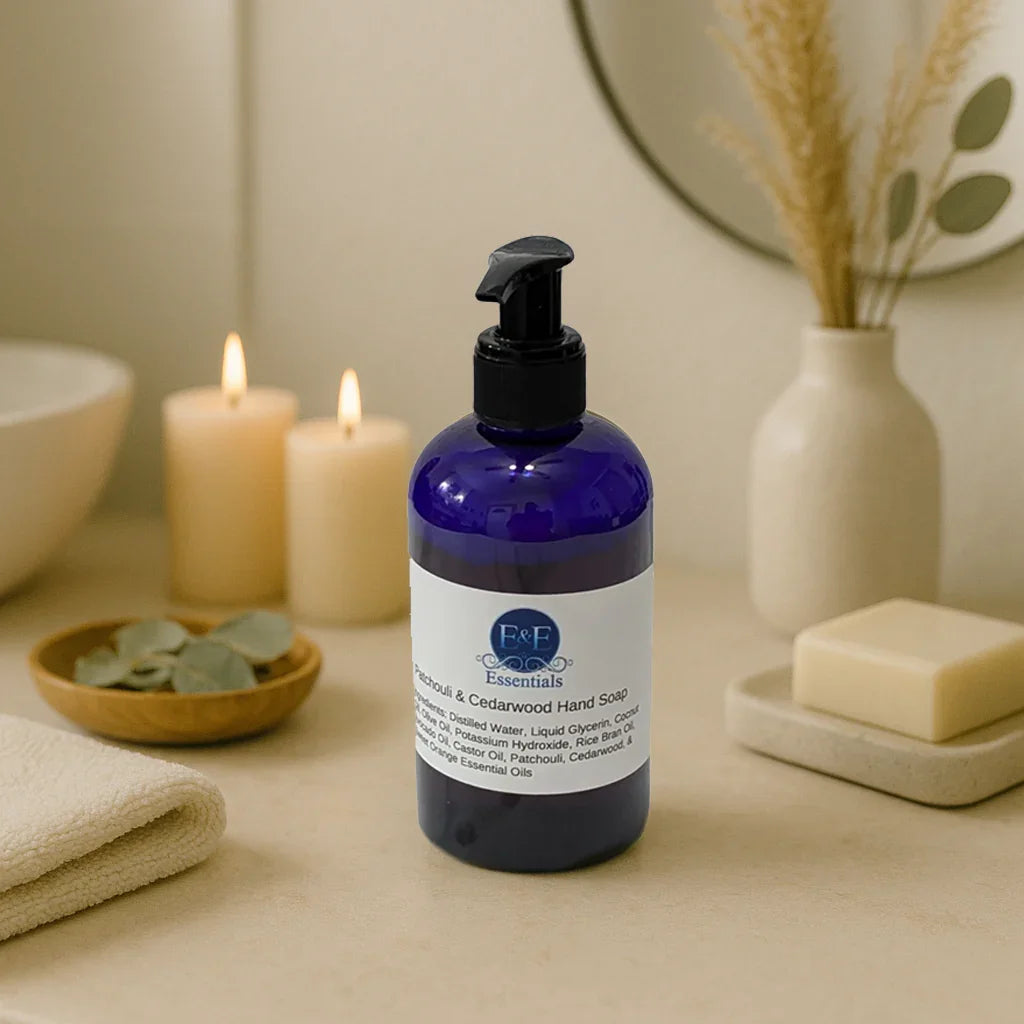 Blue bottle of Patchouli & Cedarwood liquid hand soap with pump dispenser on beige spa table with candles and towel
