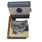 Charcoal & Sea Clay Soap bar on wooden dish with box packaging.