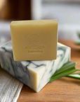 Lemongrass bar soap adorned with a fresh lemongrass stalk on top