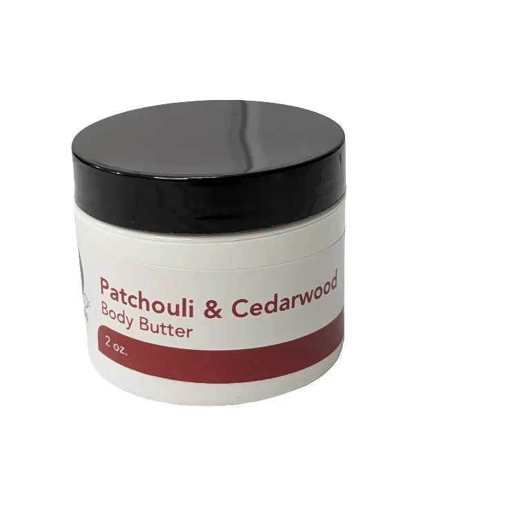 Patchouli & Cedarwood Body Butter jar with black lid, providing luxurious hydration for dry skin.