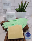 Aloe & Shea Butter Bar Soap accompanied by gloves and a small cactus on a bathroom surface