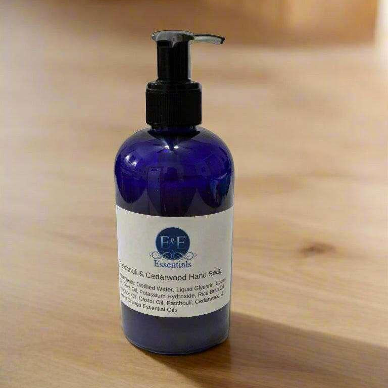 Patchouli & Cedarwood Liquid Hand Soap bottle on a wooden surface, ideal for dry and sensitive skin.