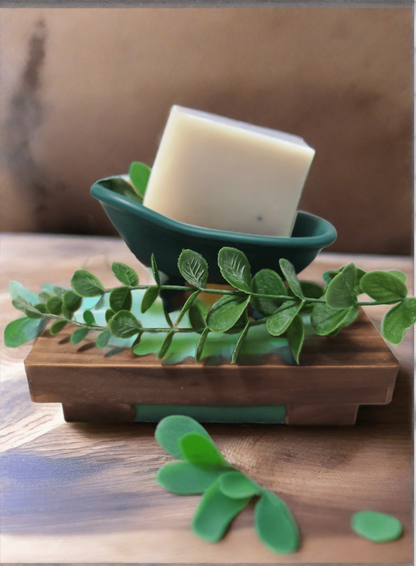 Eucalyptus & Mint Bar Soap on a wooden dish with eucalyptus leaves