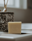 Bar of Frankincense soap placed beside a toothbrush on a bathroom countertop