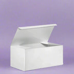 White gift box with lid against purple background, showcasing sleek, elegant design ideal for any occasion.