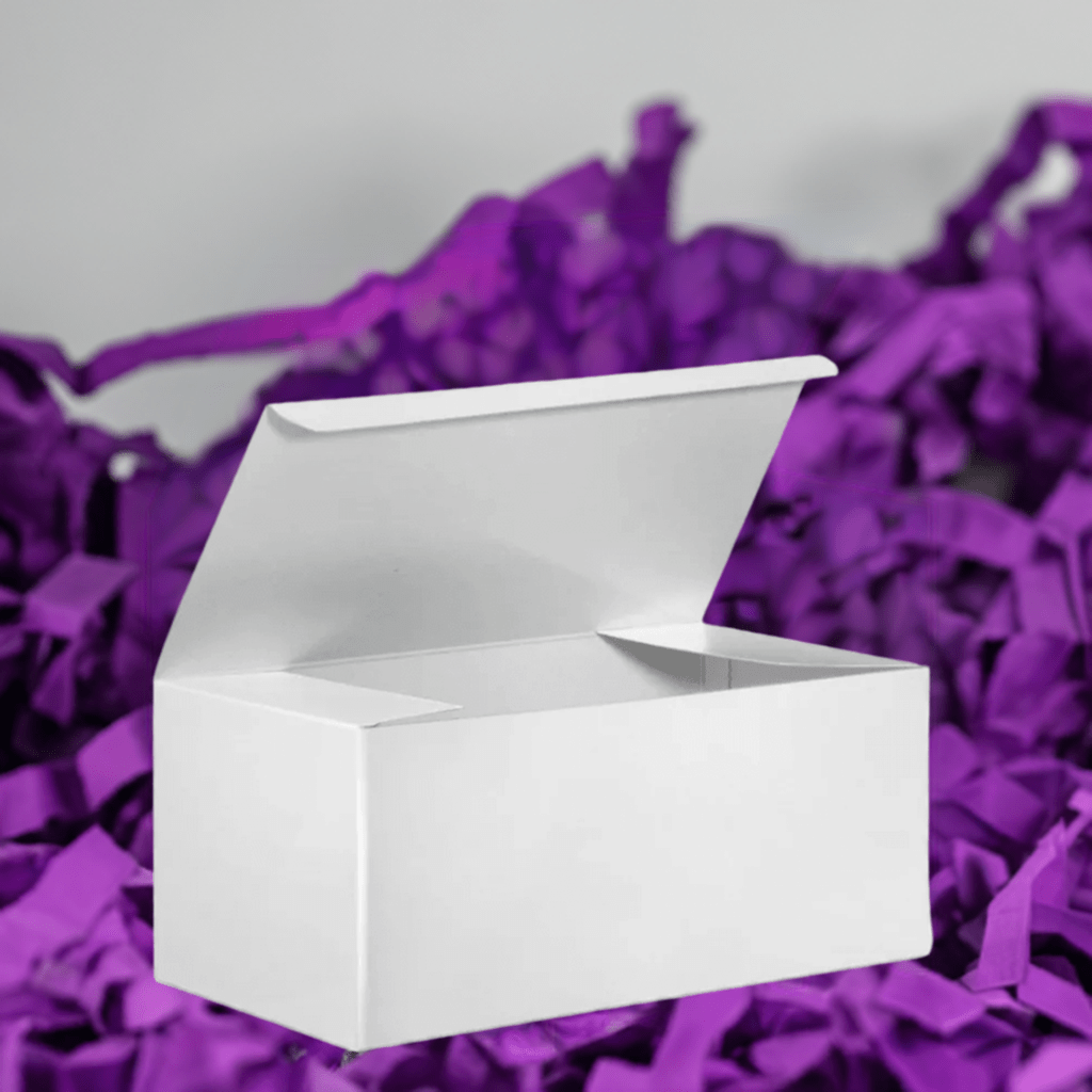 White gift box placed on purple tissue paper