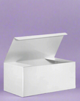 White gift box placed on a sheet of purple wrapping paper