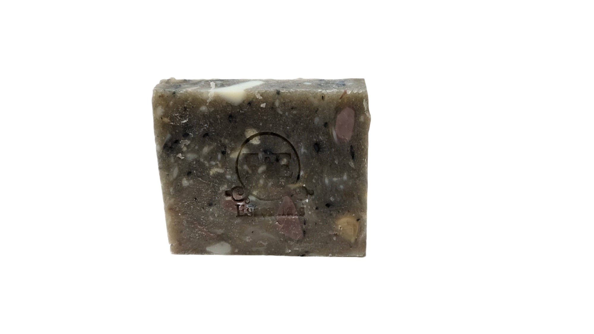 Mystery Bar Soap with an embossed design resting on a wooden slab