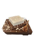 Oatmeal & Honey Bar Soap on wooden tray with oats and honey dipper.