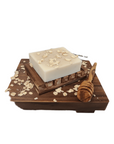 Oatmeal & Honey Bar Soap displayed on a wooden tray beside a wooden spoon