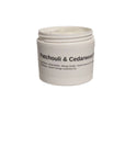 A container of Patchouli & Cedarwood Body Butter on a white surface