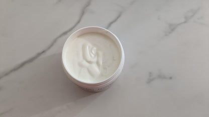 Close-up of Lavender Body Butter container on marble countertop