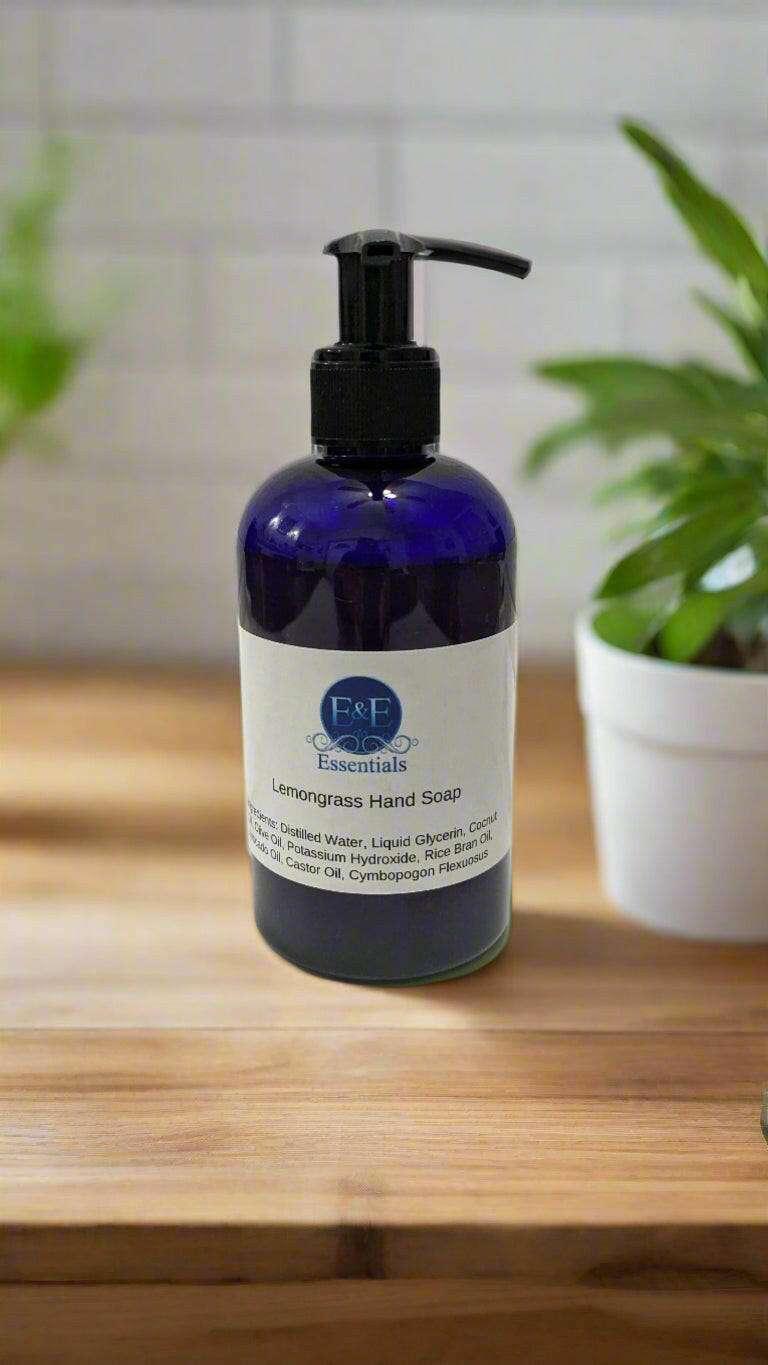 Lemongrass Liquid Hand Soap in a blue pump bottle on a wooden surface.