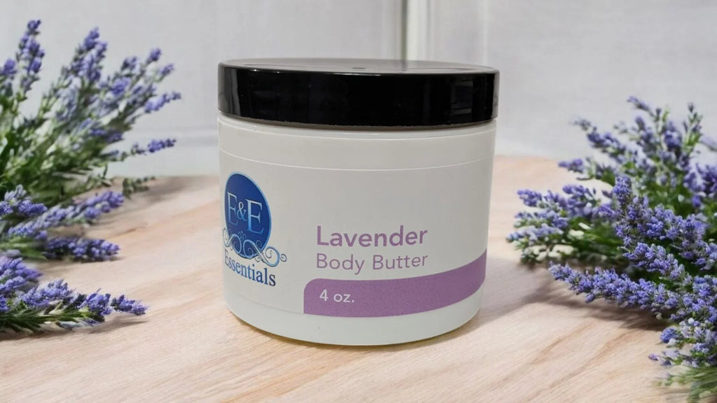 Lavender Whipped Body Butter jar amidst fresh lavender sprigs on a wooden surface.