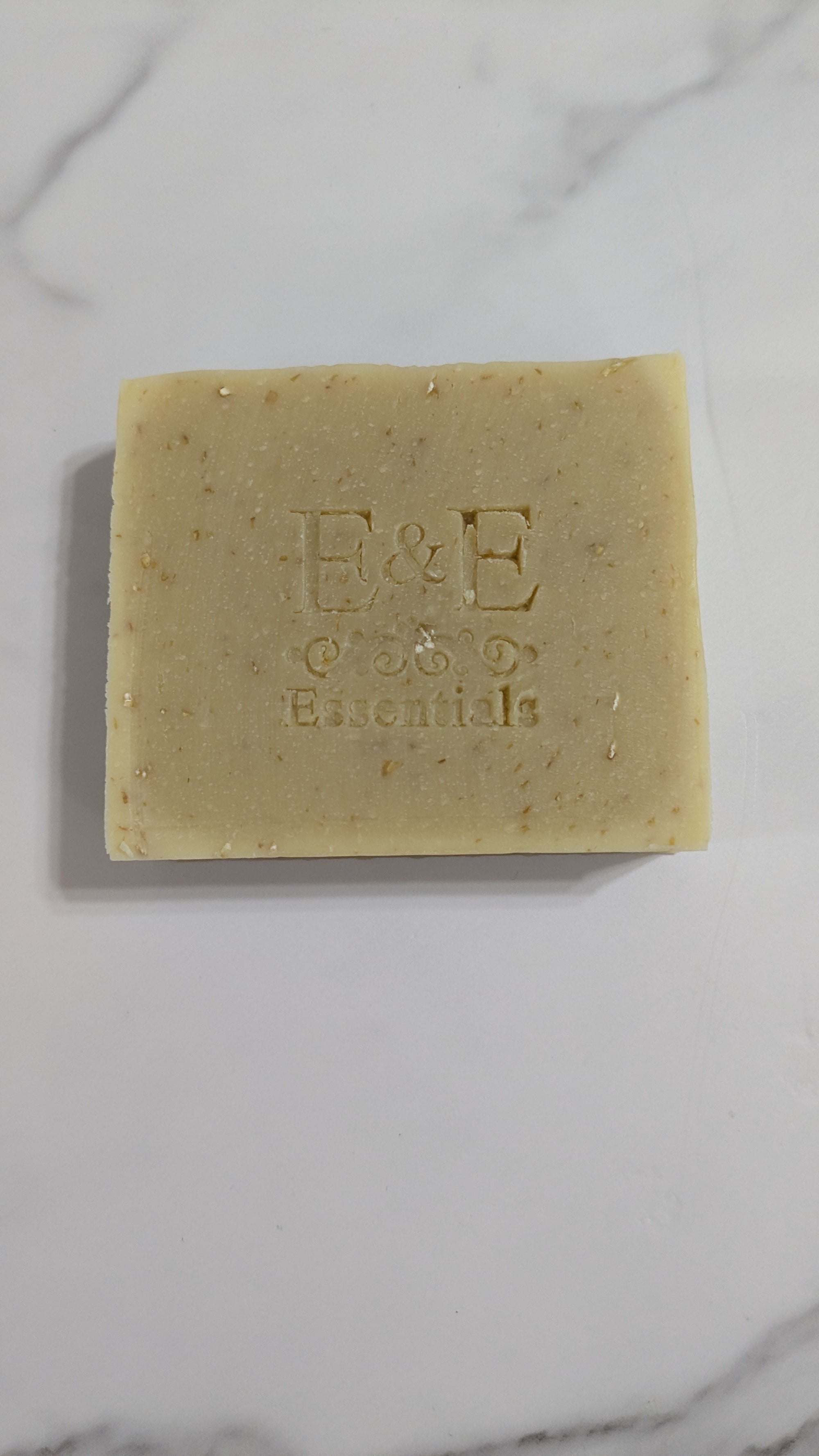 Bar of soap with 'E&E' branding on a marble surface