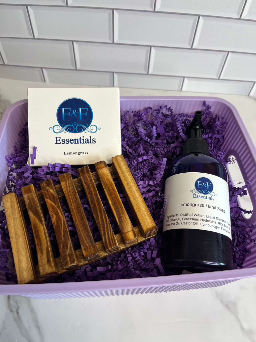 Lemongrass gift basket with soap, hand soap, wooden soap dish, and purple packaging.