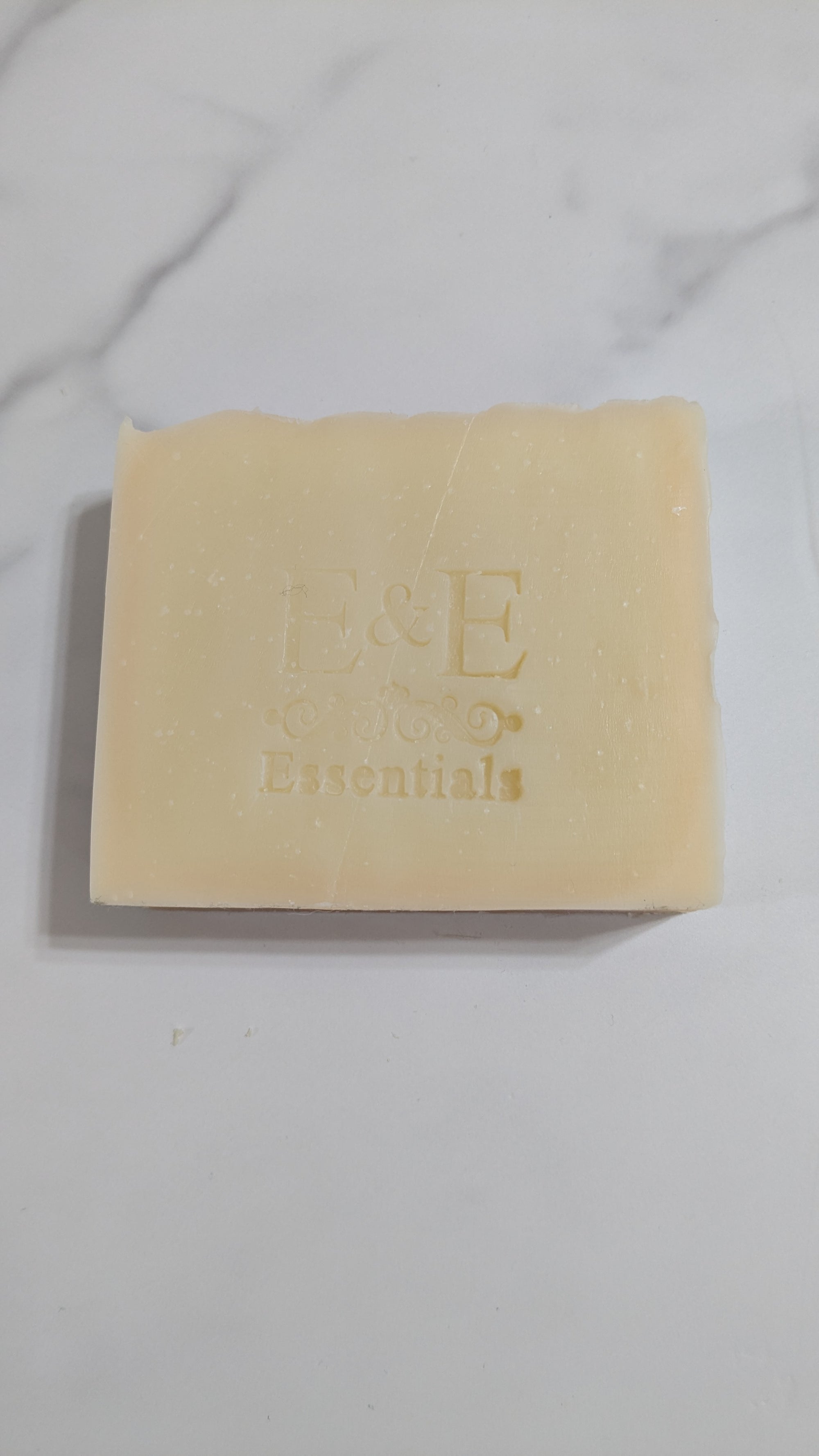 Bar of soap with 'E & E' branding on a marble surface