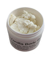 Creamy vanilla body butter in a jar positioned on marble countertop