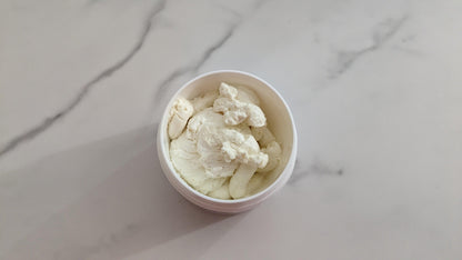 Open container of Vanilla Body Butter with creamy texture visible