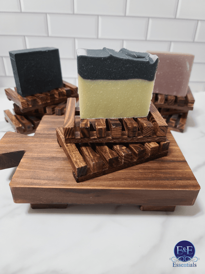 Trio of soap bars neatly arranged on a wooden soap dish